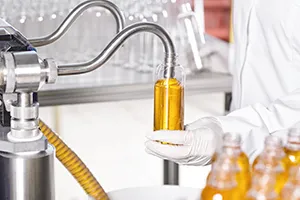 Robotic arm performing aseptic filling in pharmaceutical manufacturing