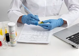 Quality control checklist being reviewed beside pharmaceutical packaging