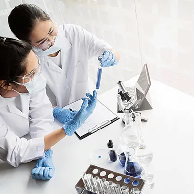 Researchers conducting laboratory experiments with test tubes and equipment